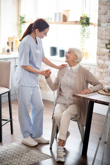 red-haired-caregiver-uniform-speaking-with-patient_259150-54